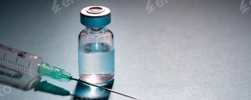 Preview: Vaccine vial dose and syringe against gray blue background