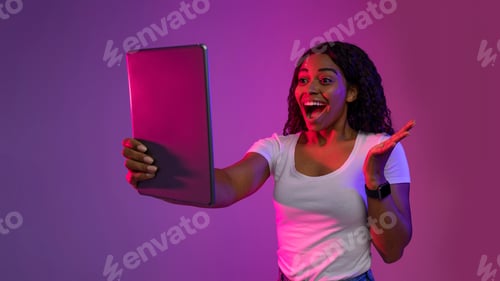 Preview: Portrait Of Excited Black Woman Looking At Digital Tablet Screen