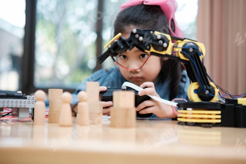 Preview: A young girl is playing with a remote control a robot