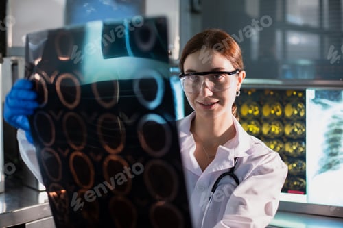 Preview: Doctor woman looking check up x-ray film in medical laboratory at hospital.