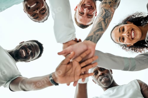 Preview: Break on three and go. Shot of a group of young friends with their hands stacked.