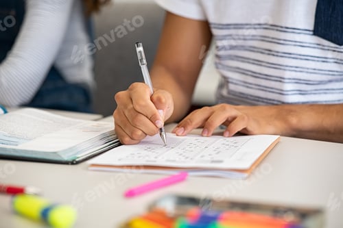 Preview: High school student filling out test answers with pen