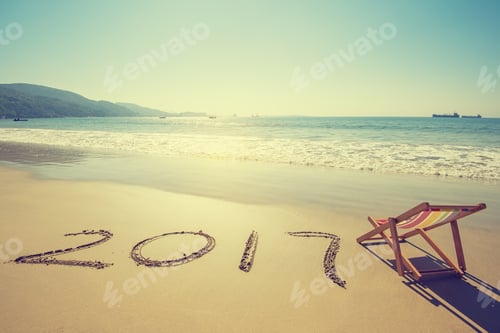 Preview: Deck Chair With 2017 Written In Sand Write On Tropical Beach.