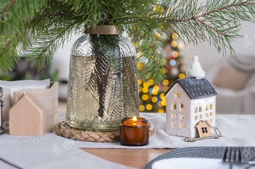 Preview: Key to the house on cozy home with Christmas decor on table of festive kitchen