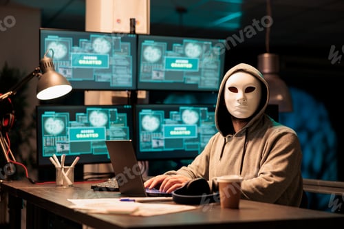 Preview: Hacker wearing mask and hood to hack computer