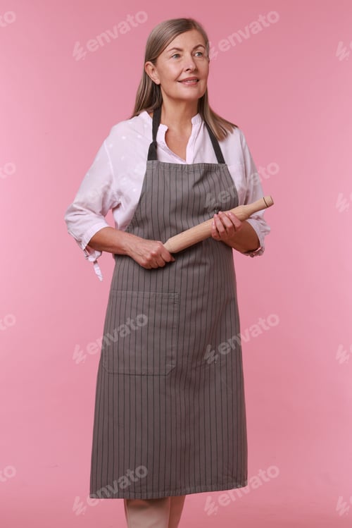 Preview: Happy woman with rolling pin on pink background