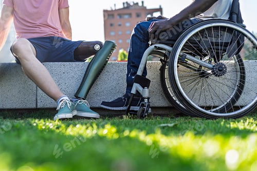 Preview: Close-up of prosthetic leg and wheelchair side-by-side outdoors