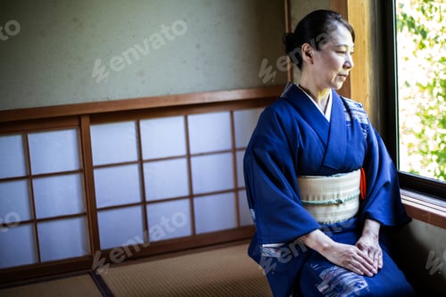 Preview: Japanese woman kneeling on floor in traditional Japanese house.