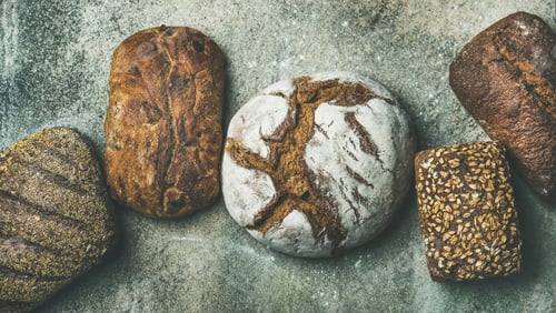 Preview: Top view of bread loaves over grey concrete background
