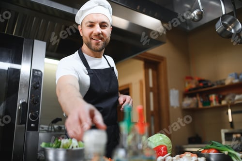 Preview: Smiling chef in his kitchen
