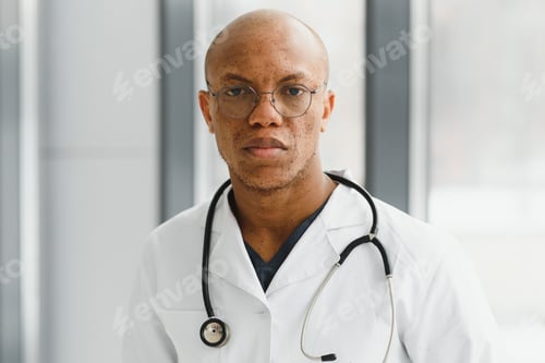 Preview: African American man male hospital doctor in white coat with stethoscope.
