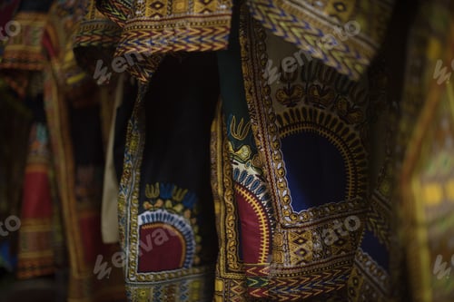 Preview: close up shot of african print clothing hanging on rack
