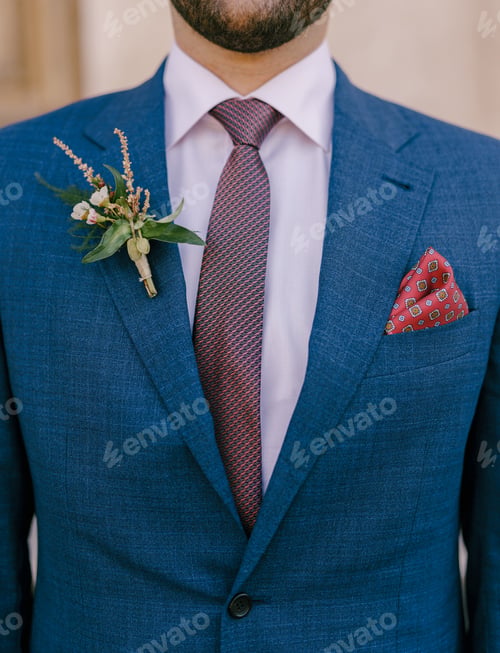 Preview: Groom in a jacket with a boutonniere on the lapel and a handkerchief in his pocket. Close-up