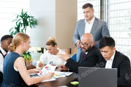 Preview: Business team collaborating on strategy in modern office setting during daytime