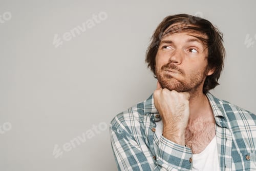 Preview: White puzzled man wearing shirt posing while looking aside