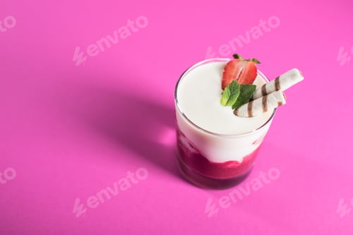 Preview: fresh milkshake with strawberry, mint and sweet straws on pink