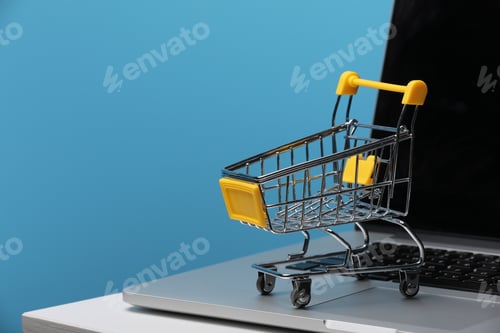 Preview: Shopping Online Concept : Mini Shopping Cart On Laptop