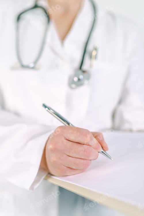 Preview: Female doctor in white uniform writing on clipboard paper