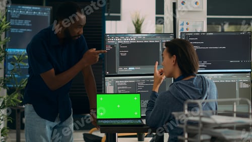 Preview: Diverse app developers working with greenscreen on laptop