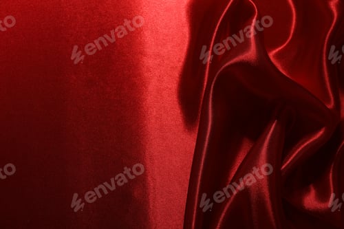 Preview: Red crumpled silk fabric as background, top view
