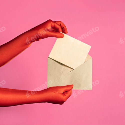 Preview: Women's hands in red gloves hold a envelope made of kraft paper on a pink background