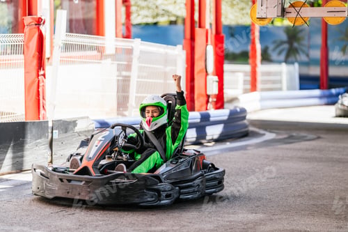 Preview: Woman celebrating go kart race victory on track