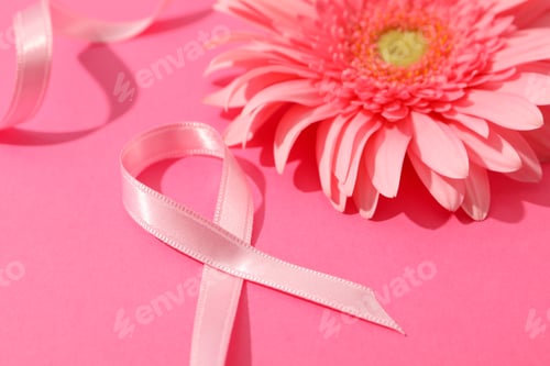 Preview: Pink awareness ribbon and gerbera on color background, space for text.