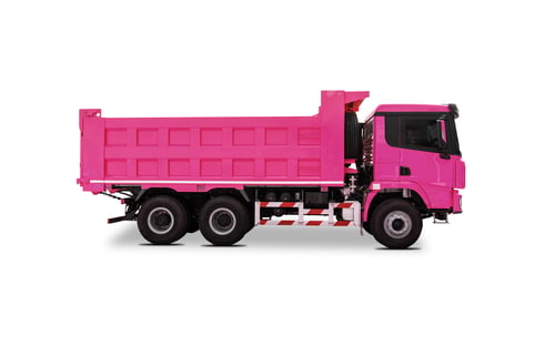 Preview: Side view of a new pink colored dump truck isolated over white background