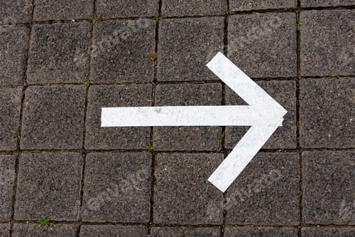 Preview: White arrow sign painted on the ground showing the direction