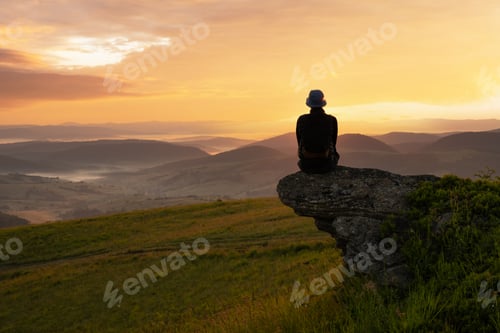 Preview: Alone tourist on the edge of the mountain hill