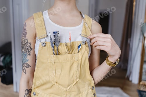 Preview: Closeup young female artist with painting instruments