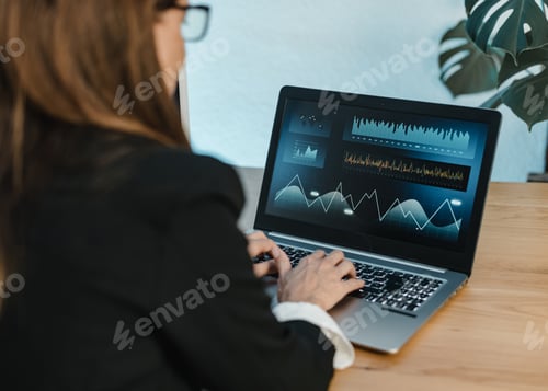Preview: Female trader typing on laptop