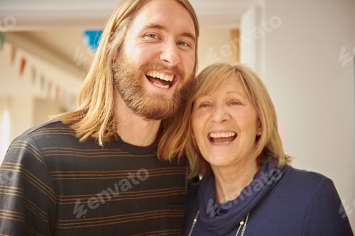 Preview: Warm and joyous moment between a young man and an older woman sharing a hearty laugh