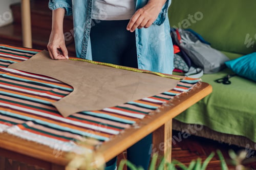 Preview: Woman tailor hands working from home and tailoring beautiful clothes