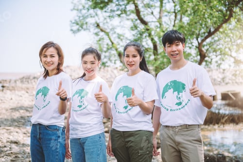 Preview: Group of Asian diverse people volunteer teamwork showing thumbs up to success the goal.