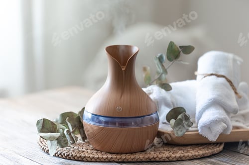 Preview: Spa composition with aroma oil diffuser lamp on a blurred background.