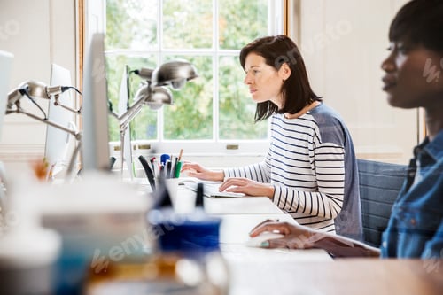 Preview: Female designers at desktop computers in creative studio