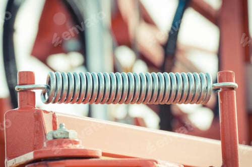 Preview: Big and hard steel spring as part and detail of industrial or agricultural machine