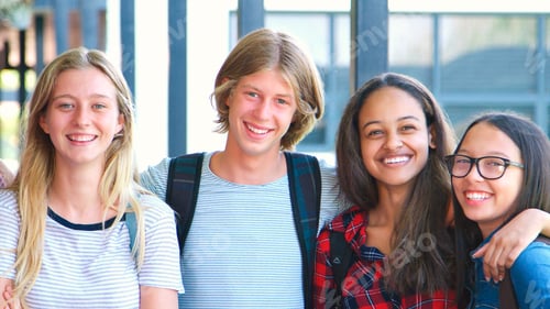 Preview: Portrait Of Smiling High School Students Wearing Backpacks Outside College Building