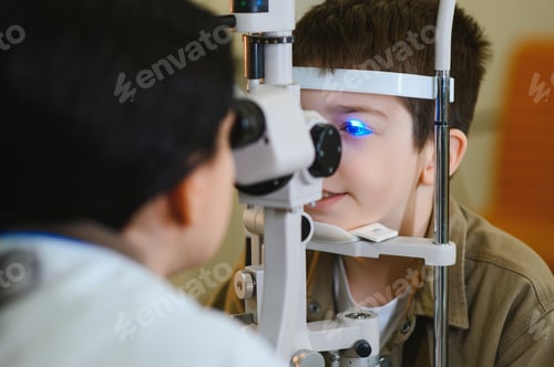 Preview: Ophthalmologist performing vision diagnostics on child with medical equipment
