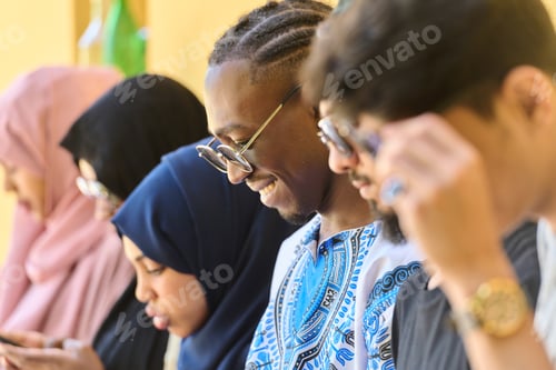 Preview: Diverse Teen Group Standing Together Against Wall Using Smartphones