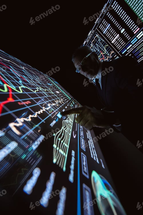 Preview: The man working on the big sensor display in the dark lab