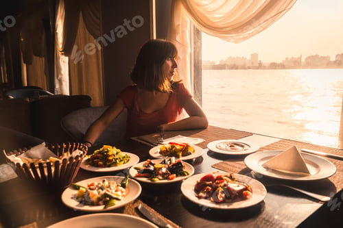 Preview: A young tourist having dinner on a boat on the nile a traditional Egyptian meal