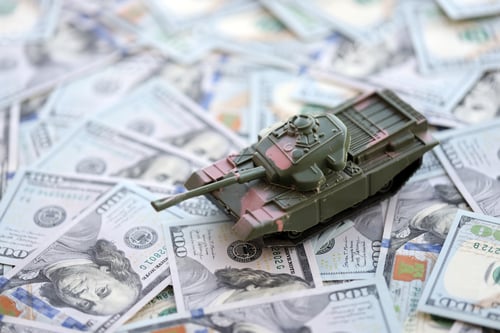 Preview: Toy tank on US hundred dollar bills banknotes. The concept of war costs, military spending
