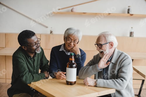 Preview: group of senior friends in bar with plastic bottle of beer