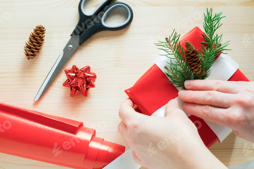 Preview: Christmas gift wrap preparation, Christmas decoration on table with present wrapping paper and gift