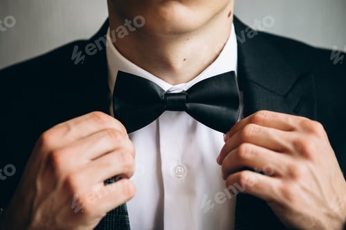Preview: Man in a Tuxedo Adjusting Bow Tie