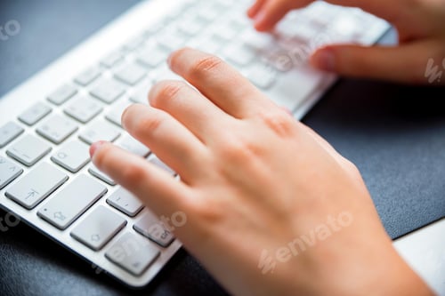 Preview: Teenage hands type on white keyboard close
