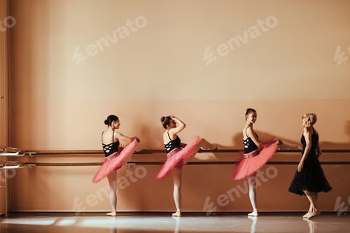 Preview: Happy ballet dancers and their teacher during a class at ballet school.
