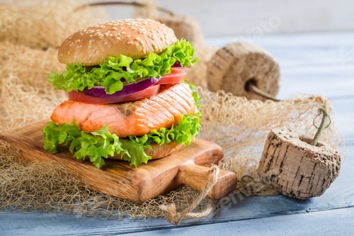 Preview: Fresh fishburger with salmon on old wooden table